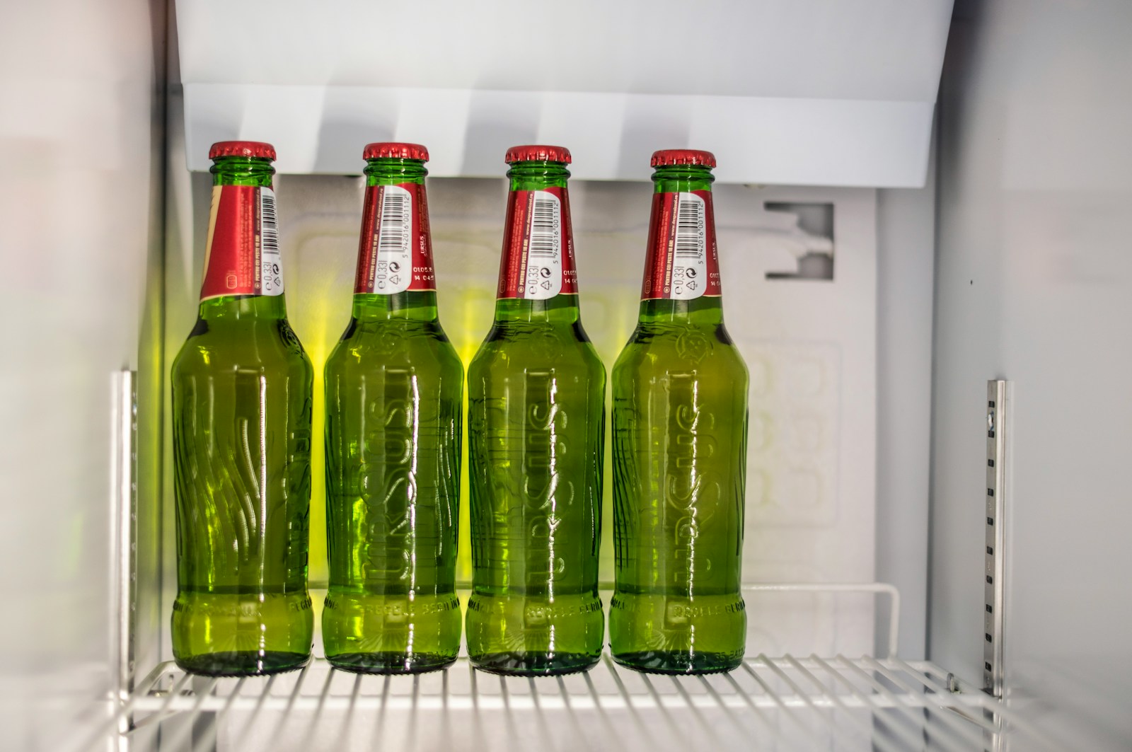 four green glass bottles